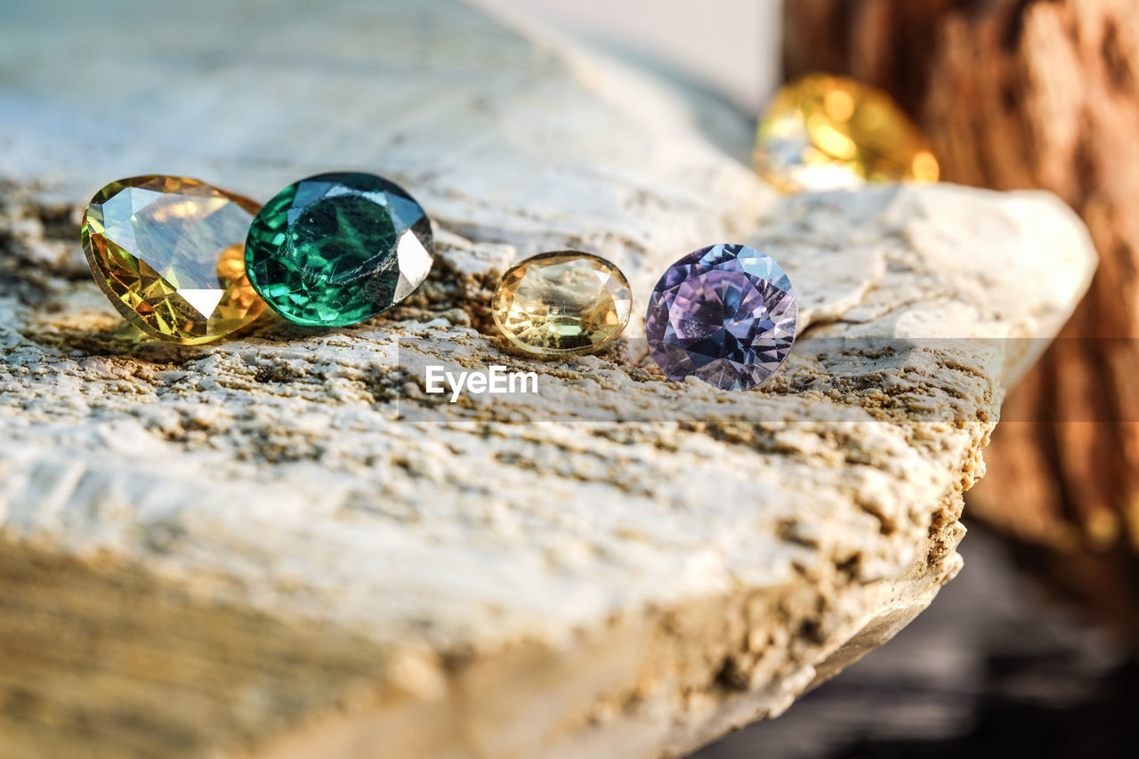 yellow, jewelry, jewellery, selective focus, fashion accessory, ring, close-up, no people, gemstone, wealth, wood, macro photography, nature, still life, gold, diamond, shiny, blue, opal, outdoors