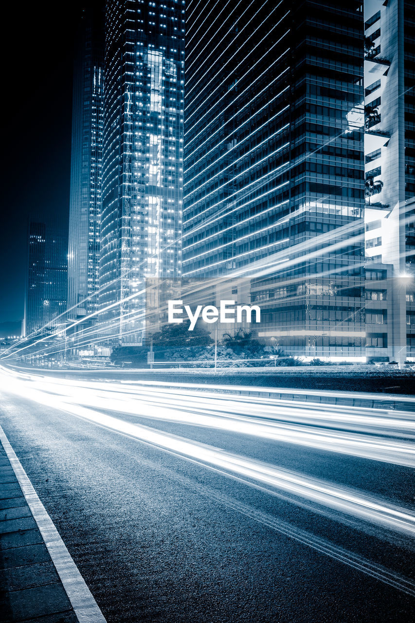 View of light trails on city street at night