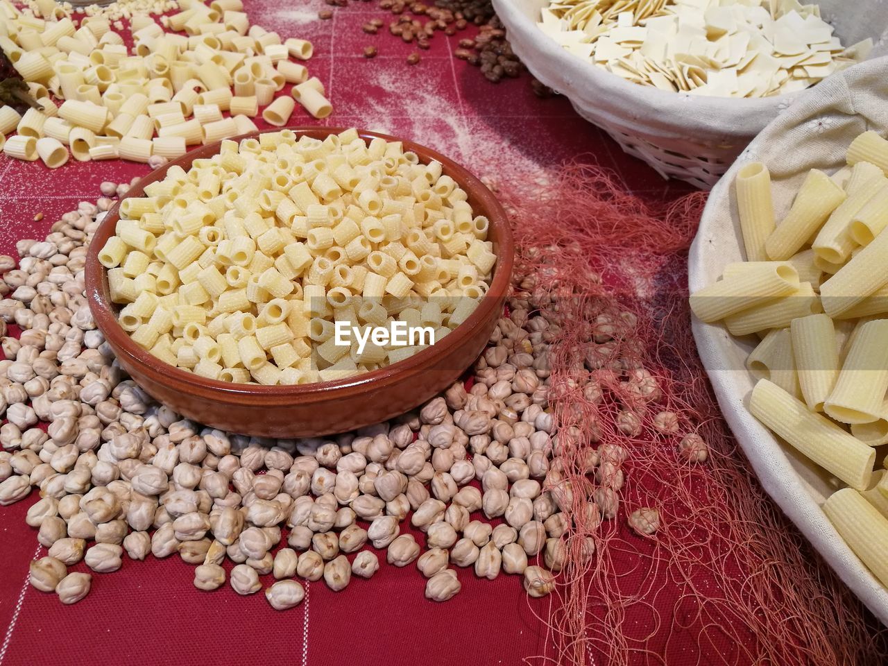 High angle view of raw pastas and chick peas on table
