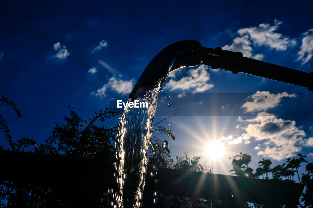 LOW ANGLE VIEW OF SILHOUETTE TREES AGAINST BLUE SKY ON SUNNY DAY