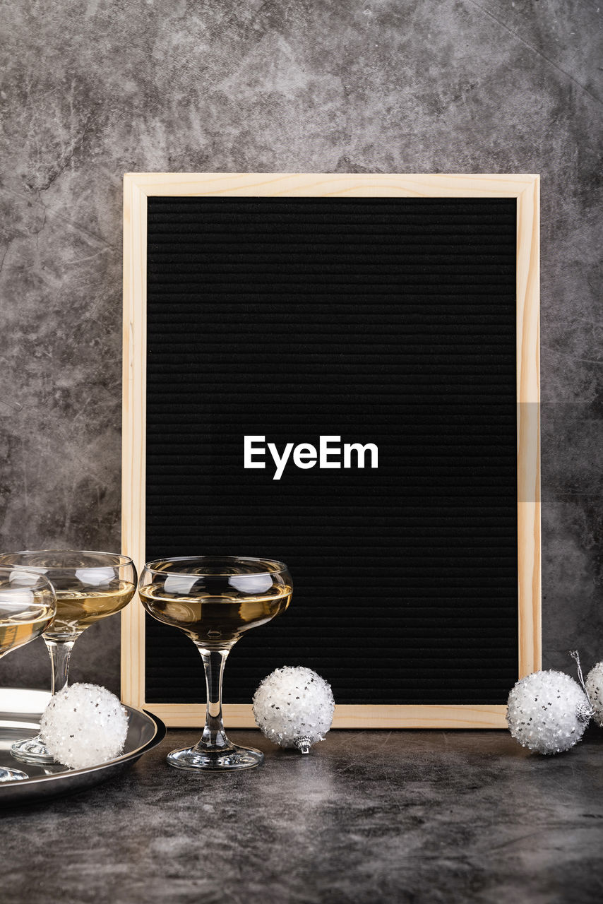 New year concept. empty black felt letter board with champagne glasses and new year decorations