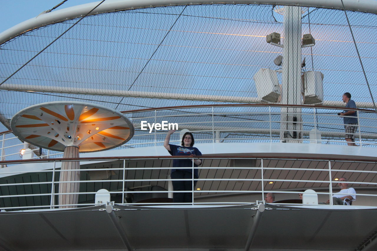 LOW ANGLE VIEW OF PEOPLE ON BOAT