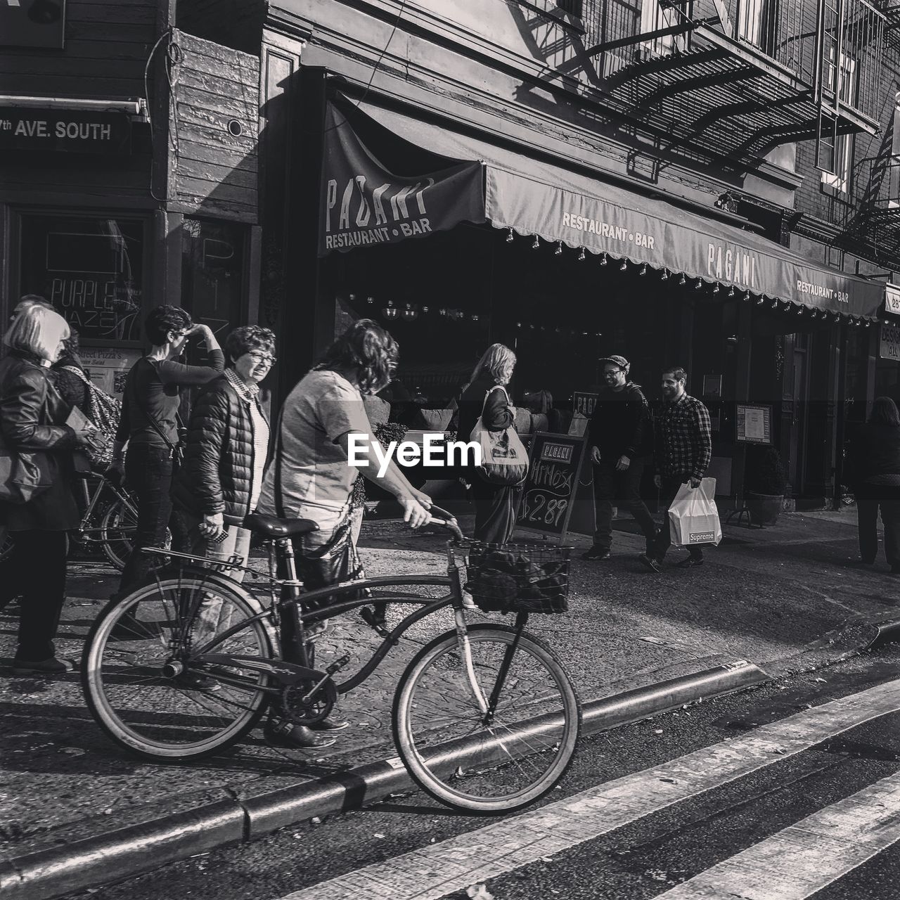 WOMAN STANDING ON CITY STREET