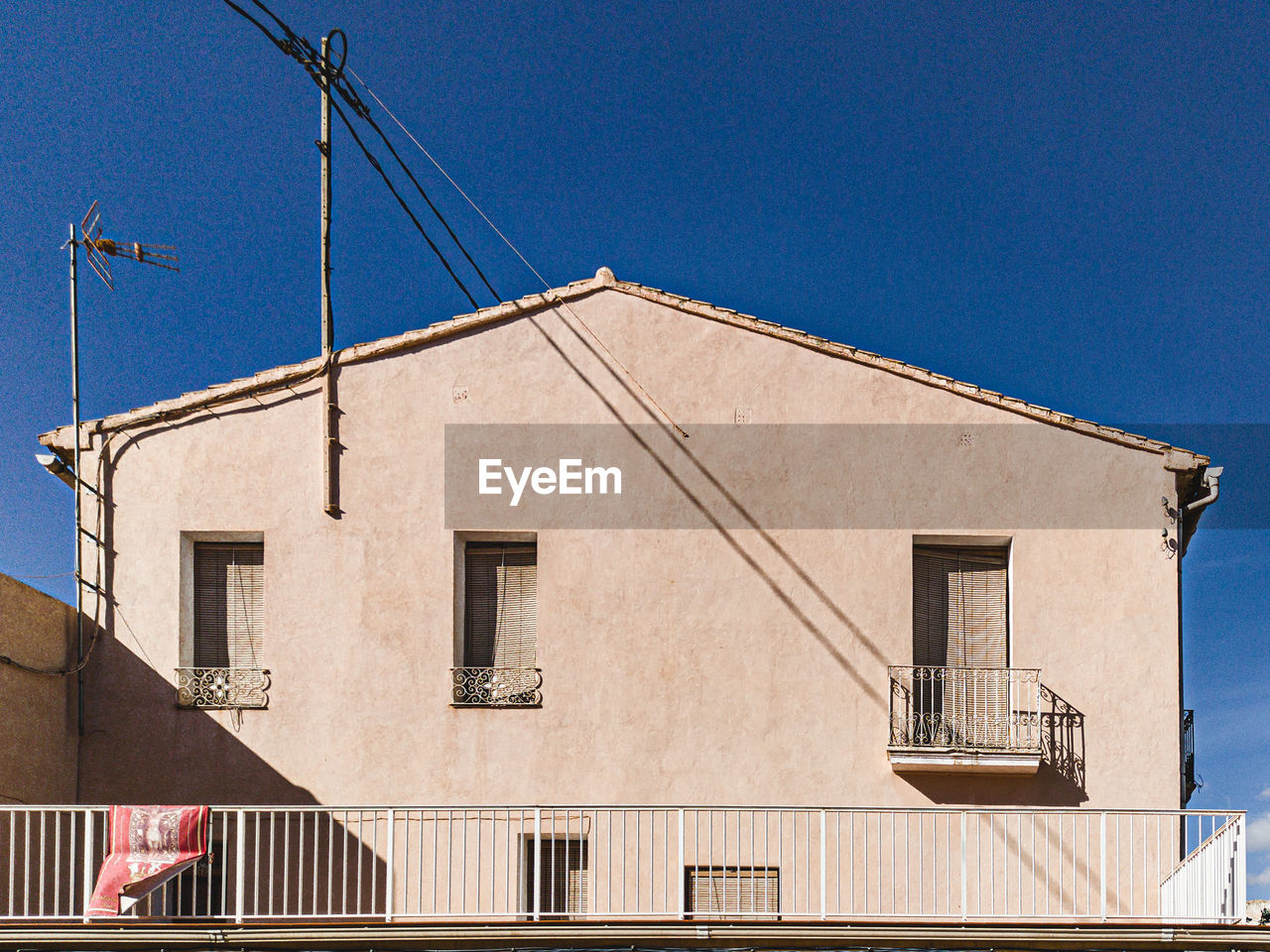 Low angle view of building against clear blue sky