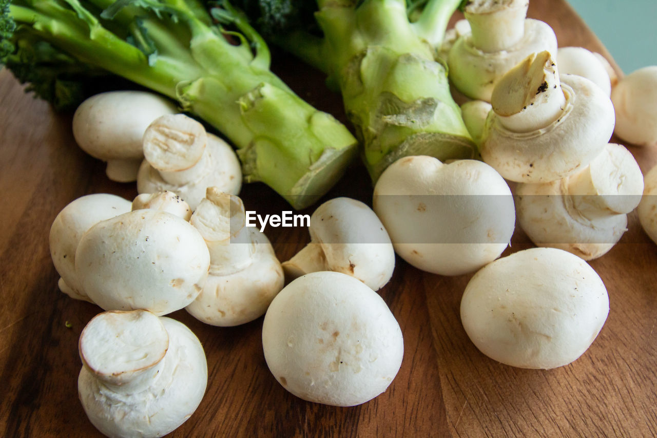 HIGH ANGLE VIEW OF CHOPPED MUSHROOMS ON WHITE TABLE