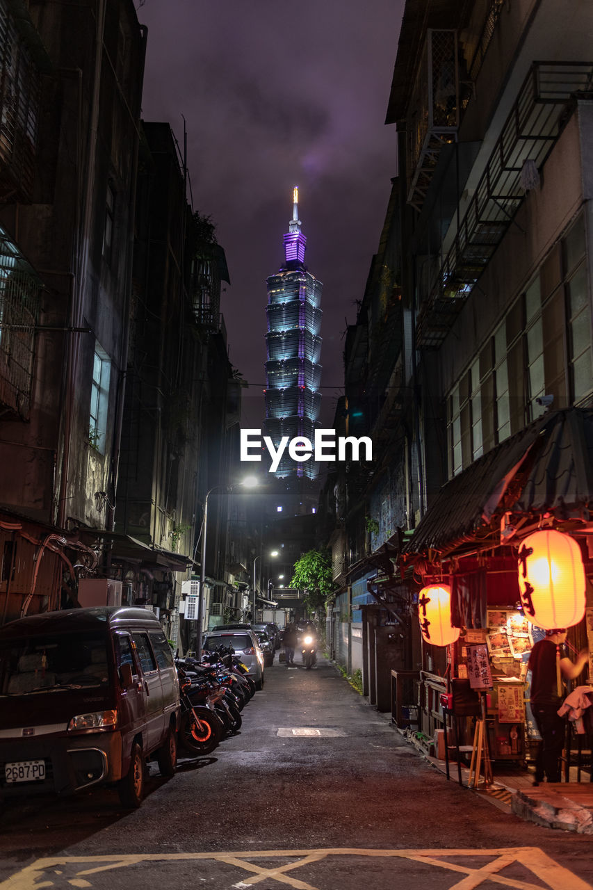 ILLUMINATED CITY STREET AND BUILDINGS AT NIGHT