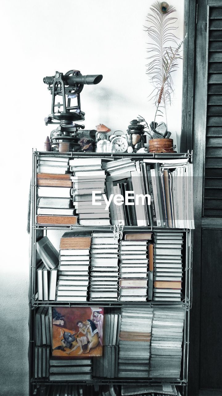 STACK OF BOOKS ON SHELF IN KITCHEN