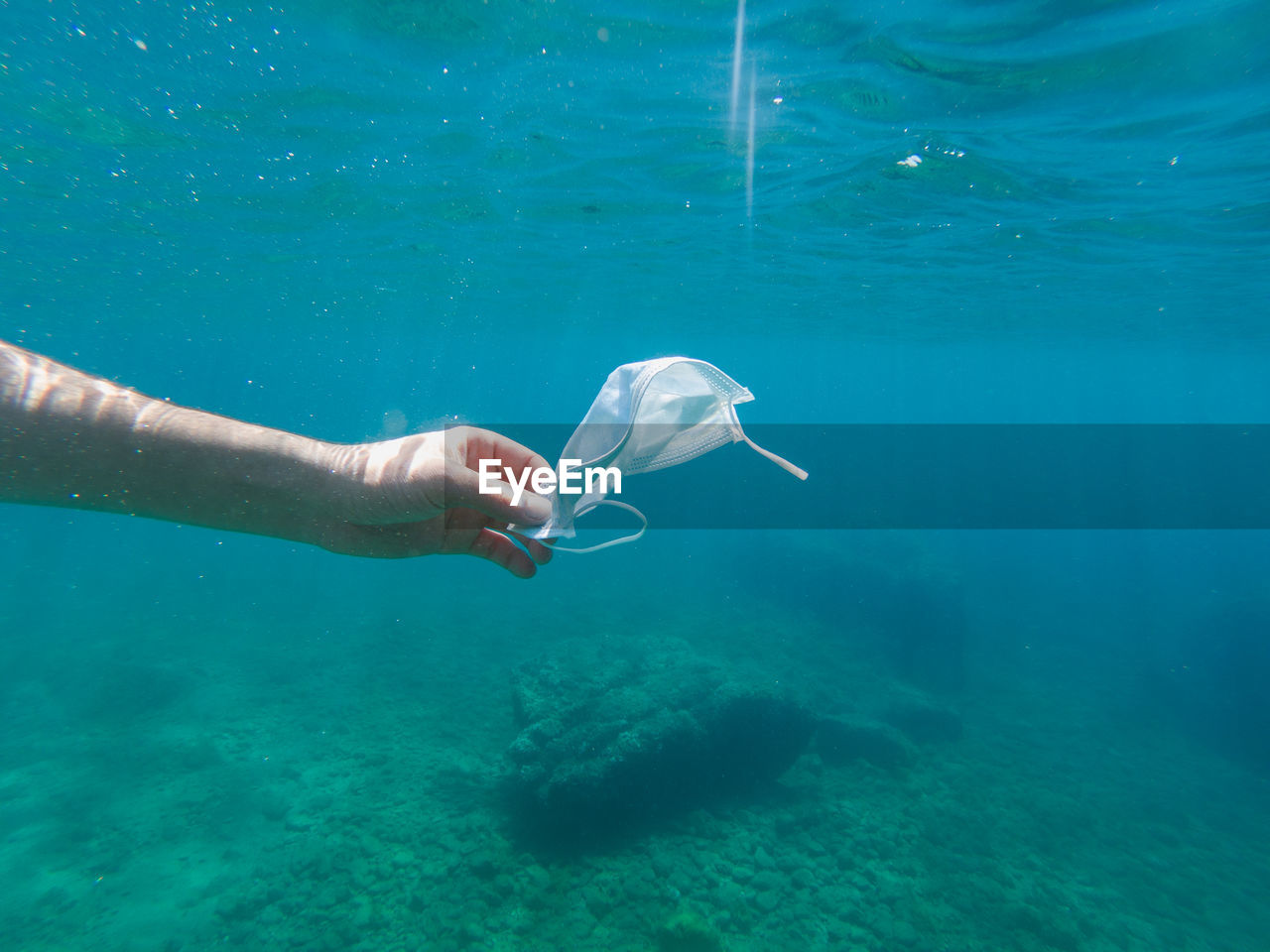 YOUNG WOMAN SWIMMING IN SEA