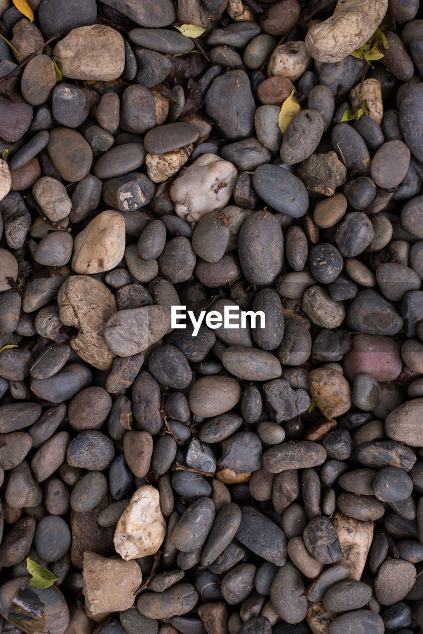 HIGH ANGLE VIEW OF PEBBLES ON STONE