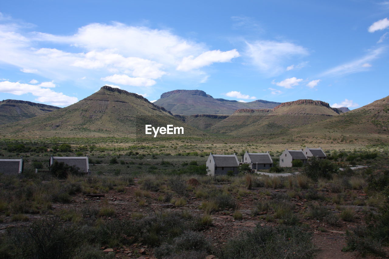 SCENIC VIEW OF FIELD AND MOUNTAINS AGAINST SKY