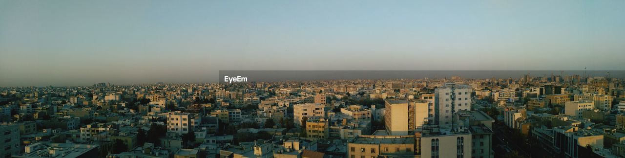 Panoramic view of cityscape against clear sky