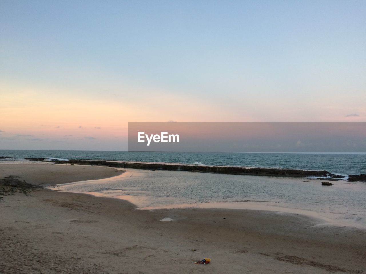 SCENIC VIEW OF BEACH DURING SUNSET