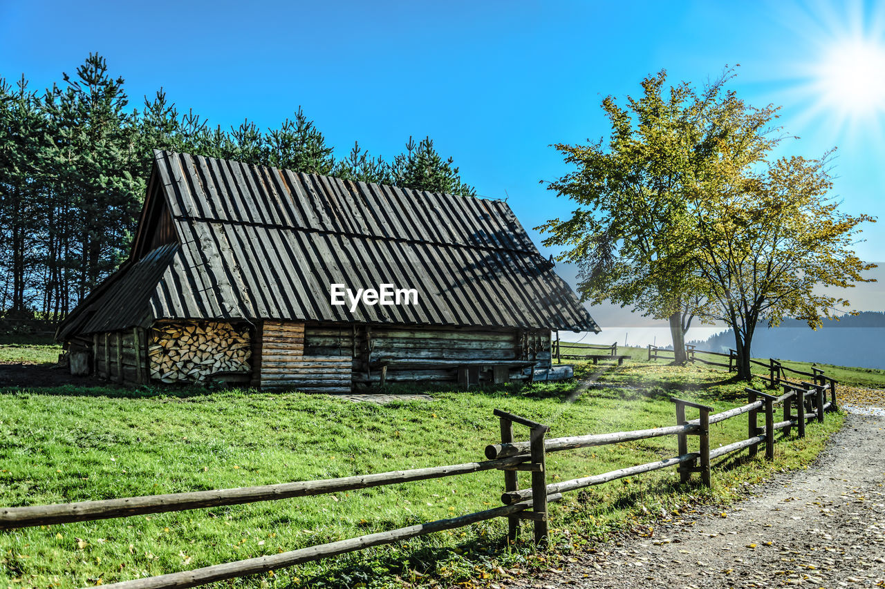 BARN IN FIELD AGAINST CLEAR SKY