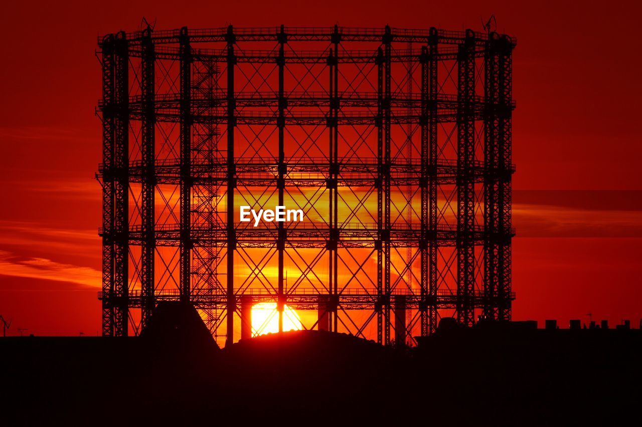 Low angle view of silhouette built structure against sky during sunset