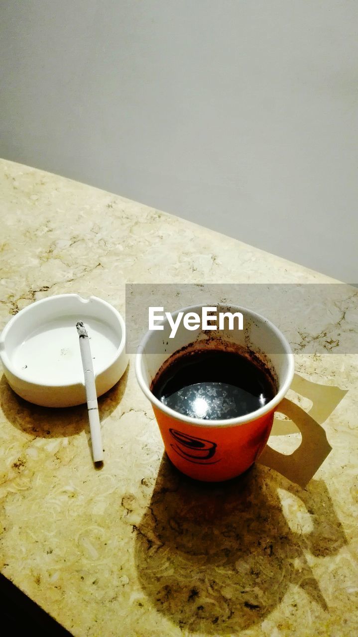 CLOSE-UP OF DRINK WITH TEA ON TABLE