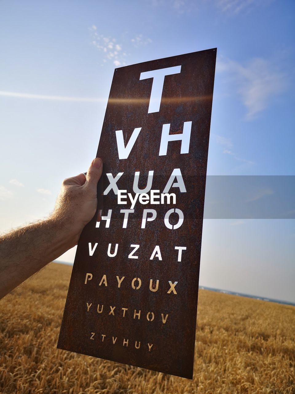 sky, nature, cloud, text, one person, communication, hand, land, sign, landscape, number, font, day, adult, sunlight