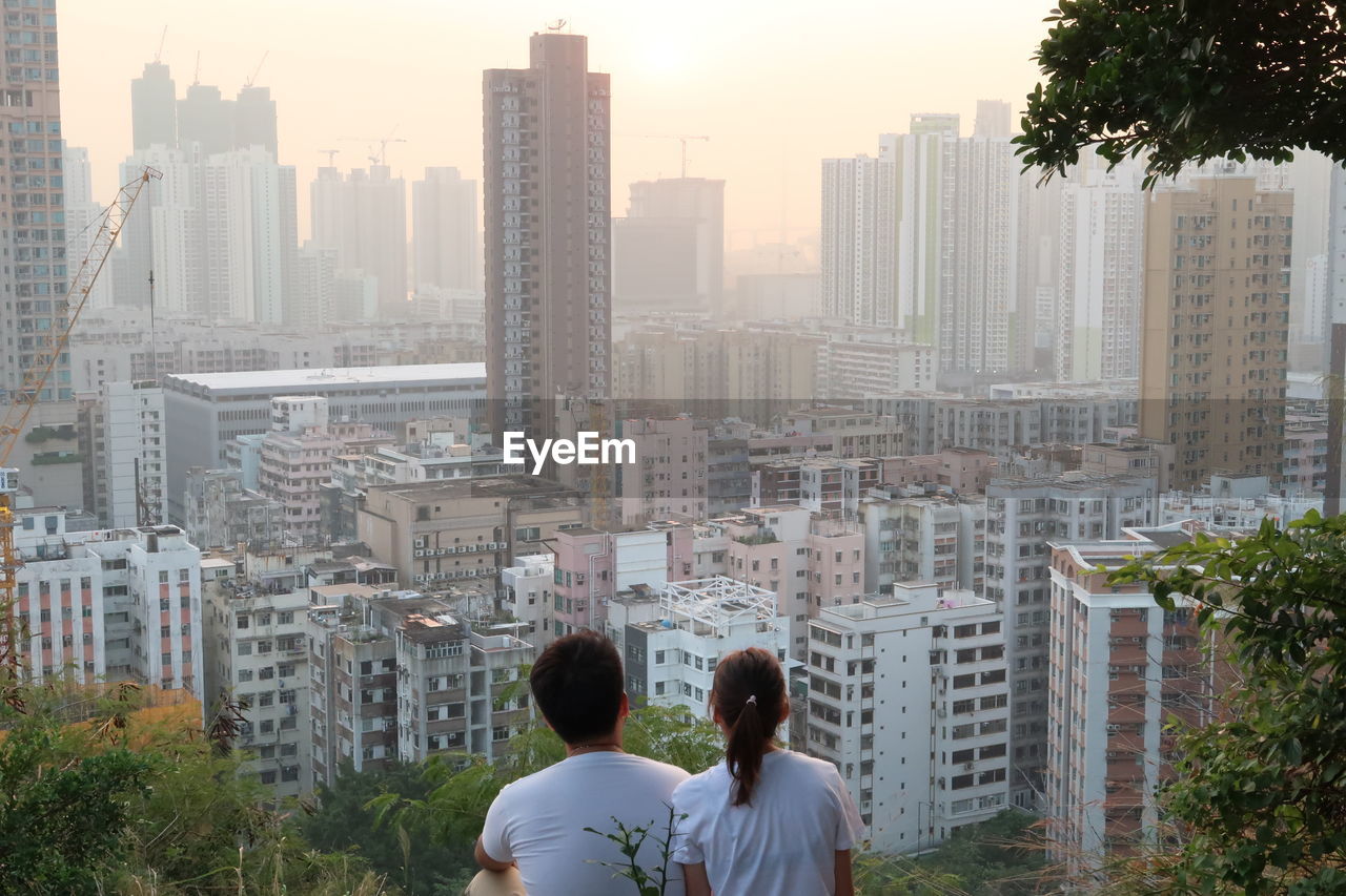 Rear view of man and buildings in city