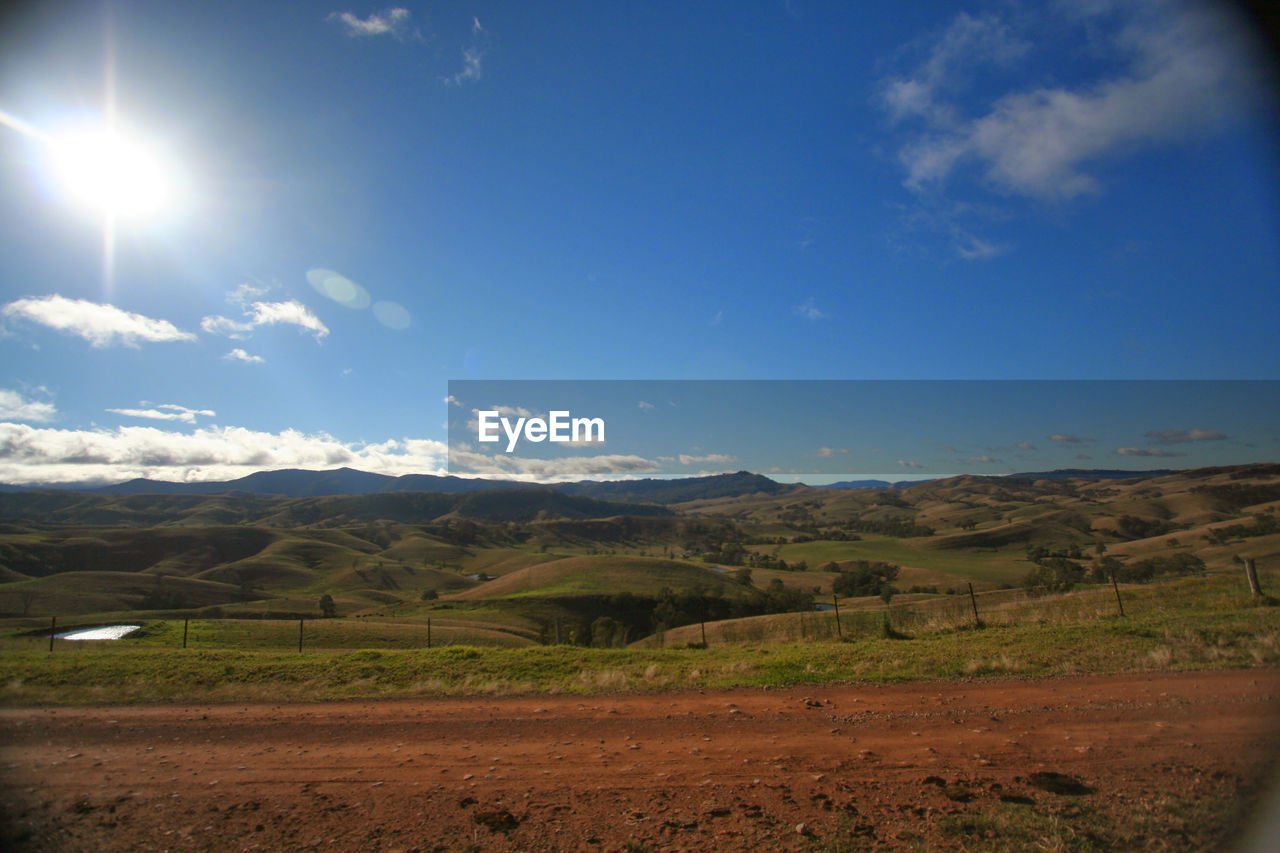 SCENIC VIEW OF FIELD AGAINST BRIGHT SKY