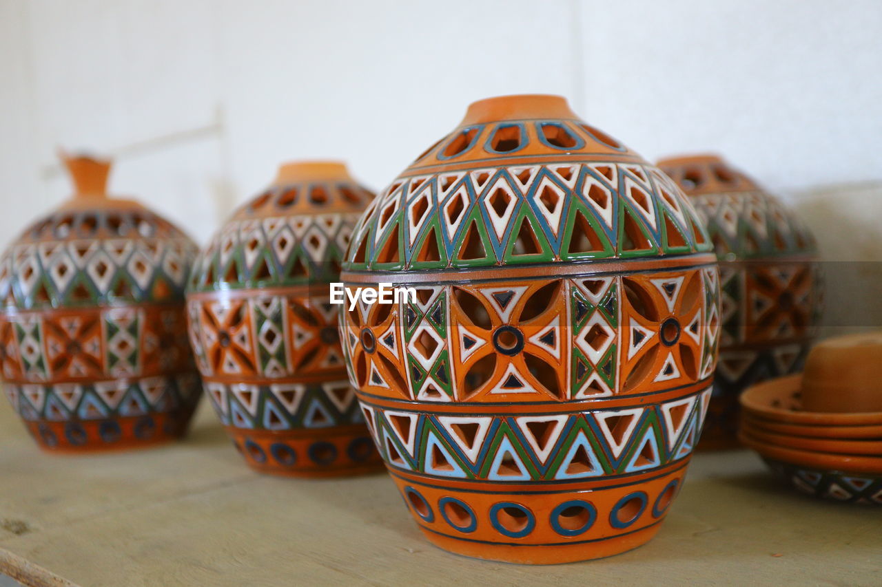 Close-up of multi colored pencils on table pottery teapot clay ornament handmade