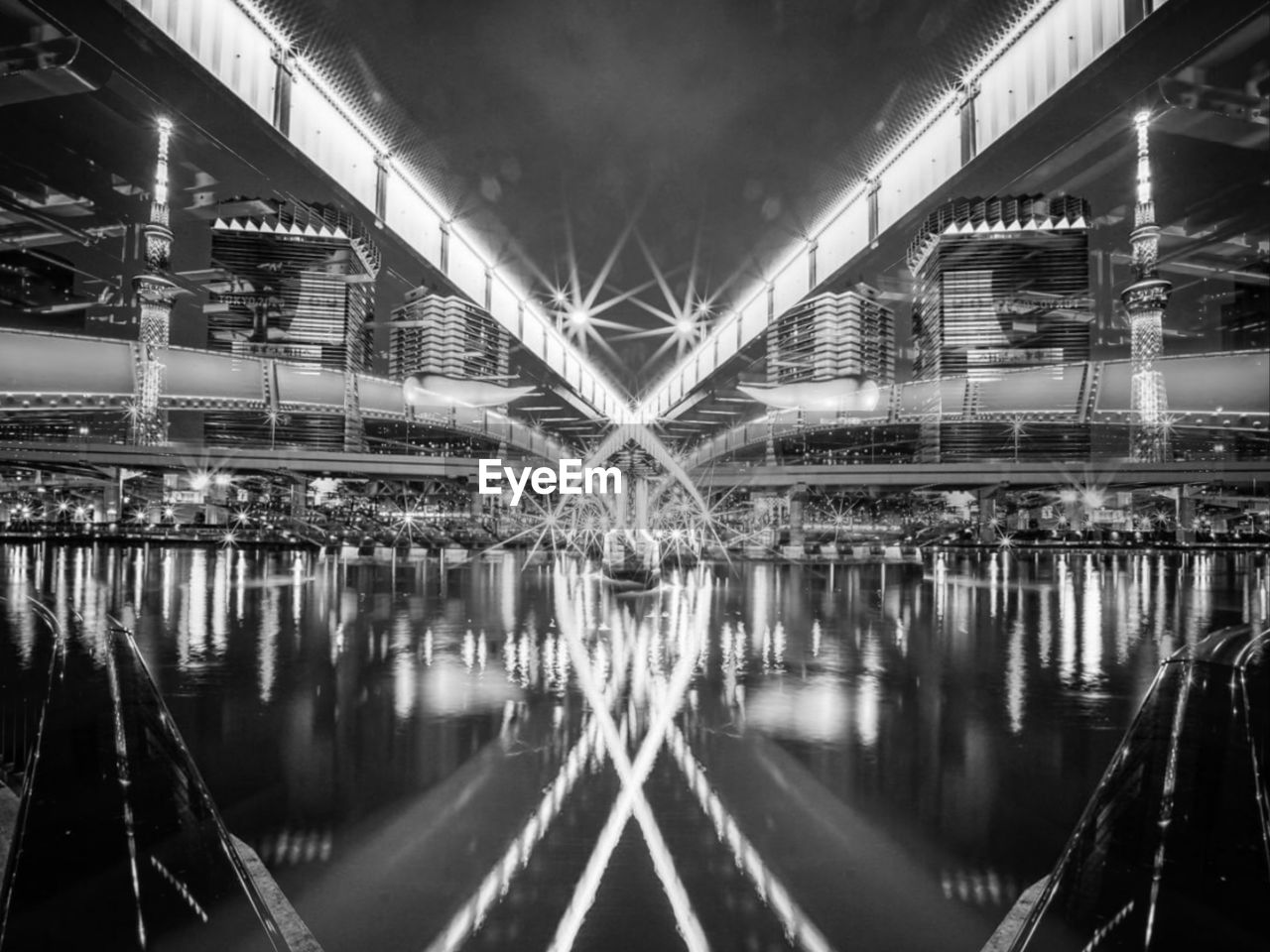 Digital composite image of illuminated bridge at night