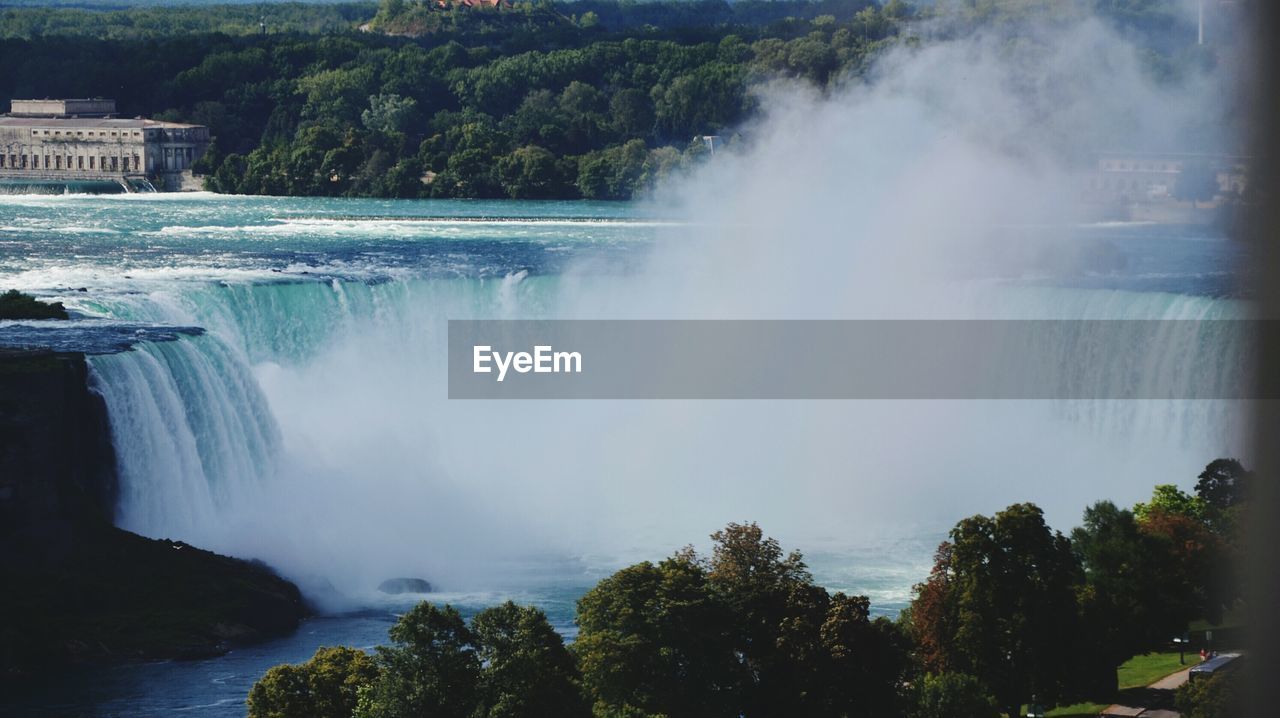 Scenic shot of waterfall against plants