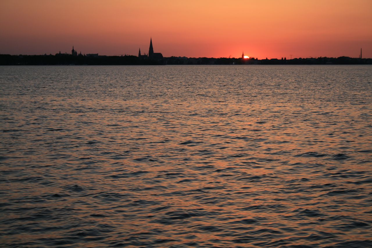 Silhouette of cityscape at sunset