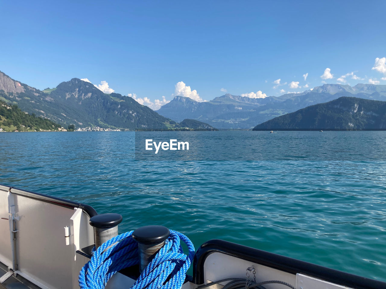 Scenic view of lake and mountains against blue sky