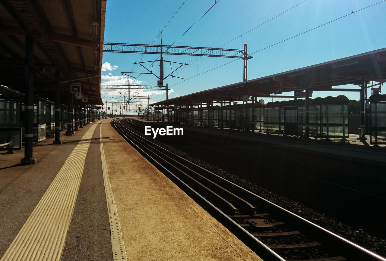 RAILROAD TRACKS ON RAILROAD STATION PLATFORM