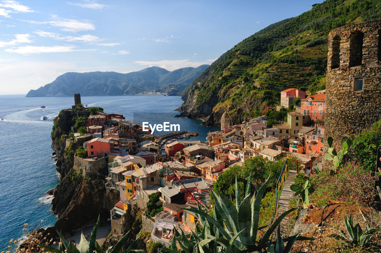 High angle view of sea and mountains against sky