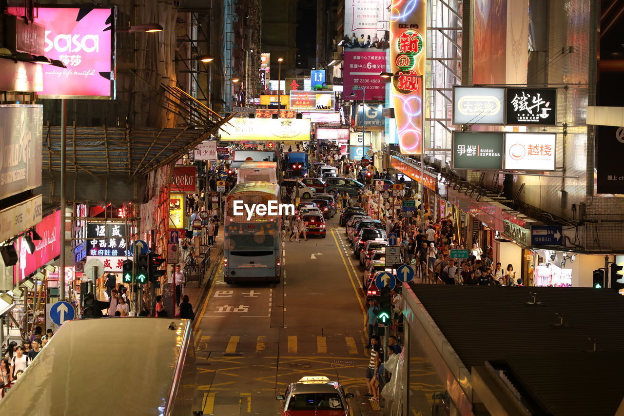 People on street in illuminated at night