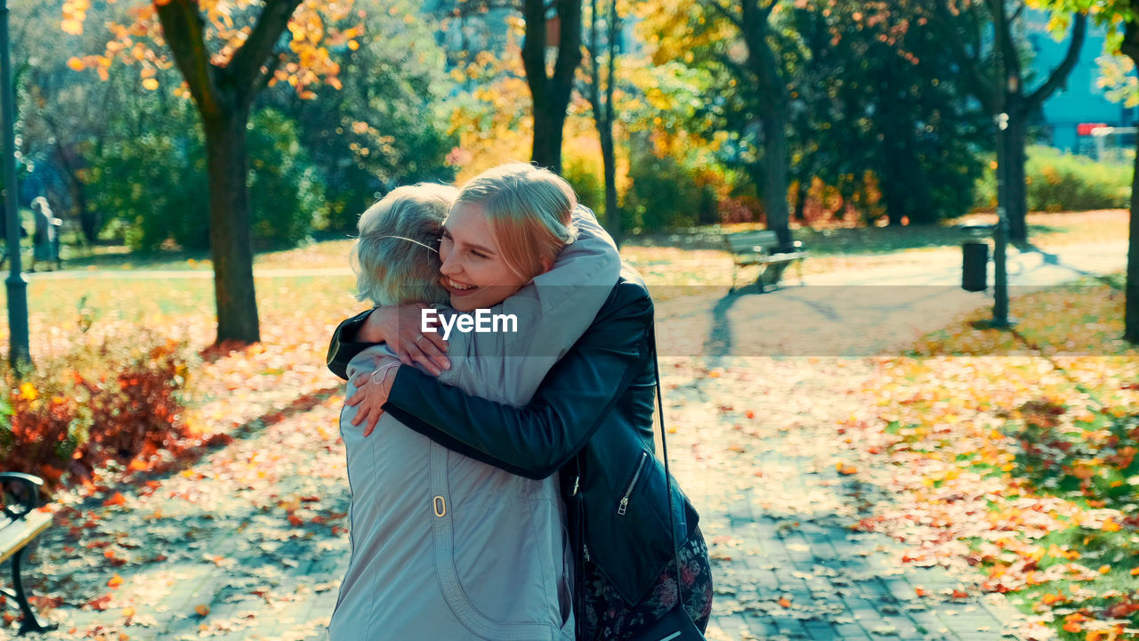 Couple kissing in park during autumn