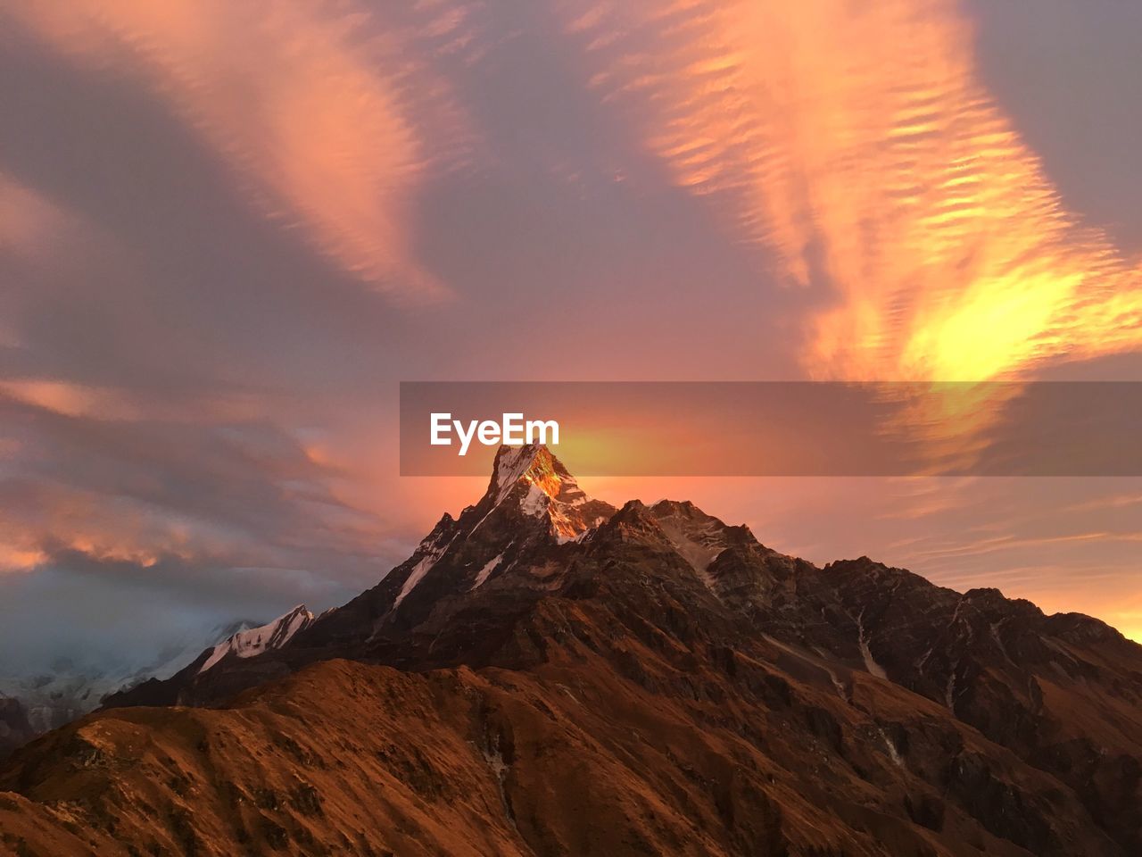 Scenic view of mountains against sky at sunset
