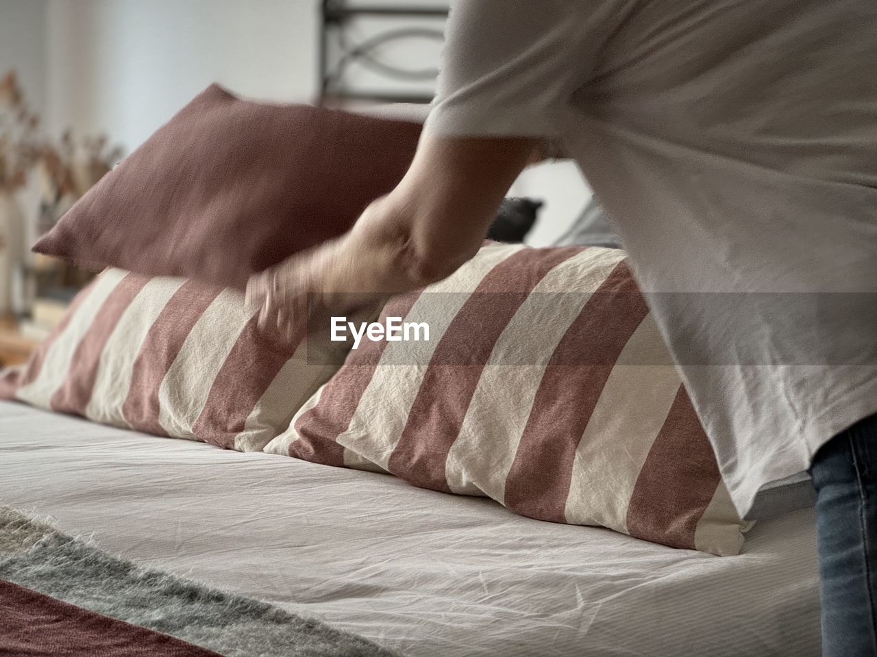low section of man lying on bed at home