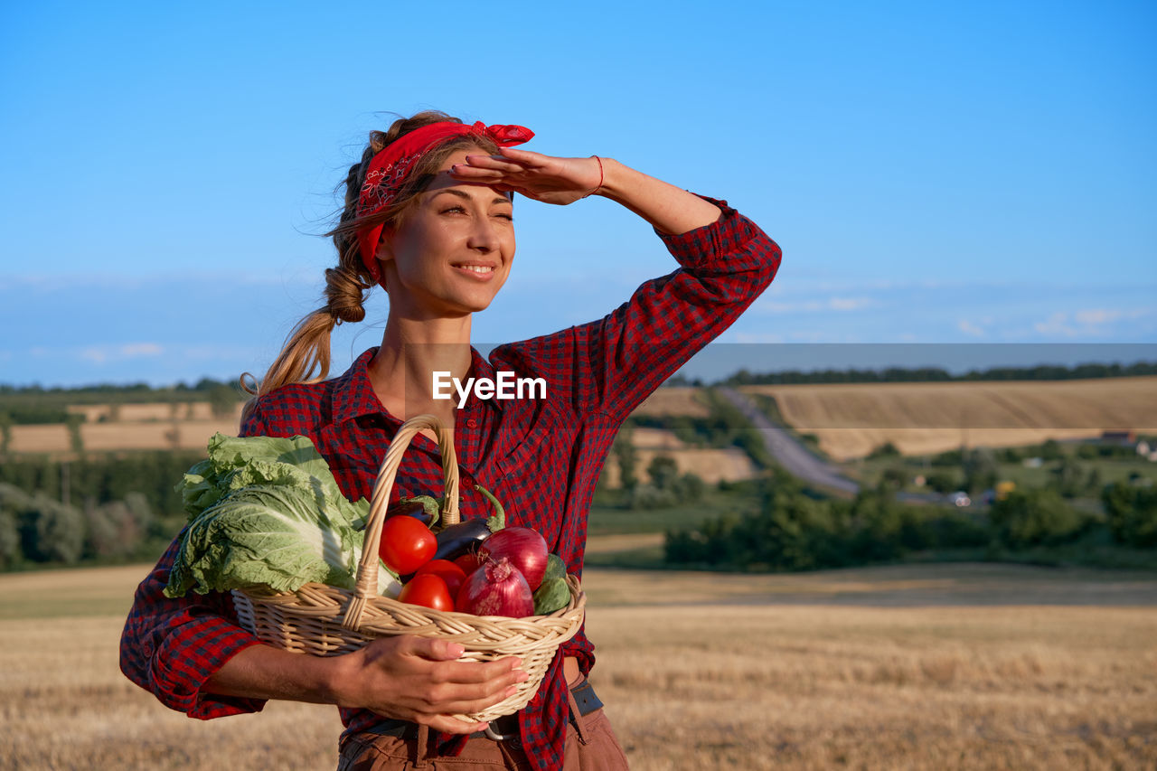 FULL LENGTH OF WOMAN IN BASKET ON ROCK