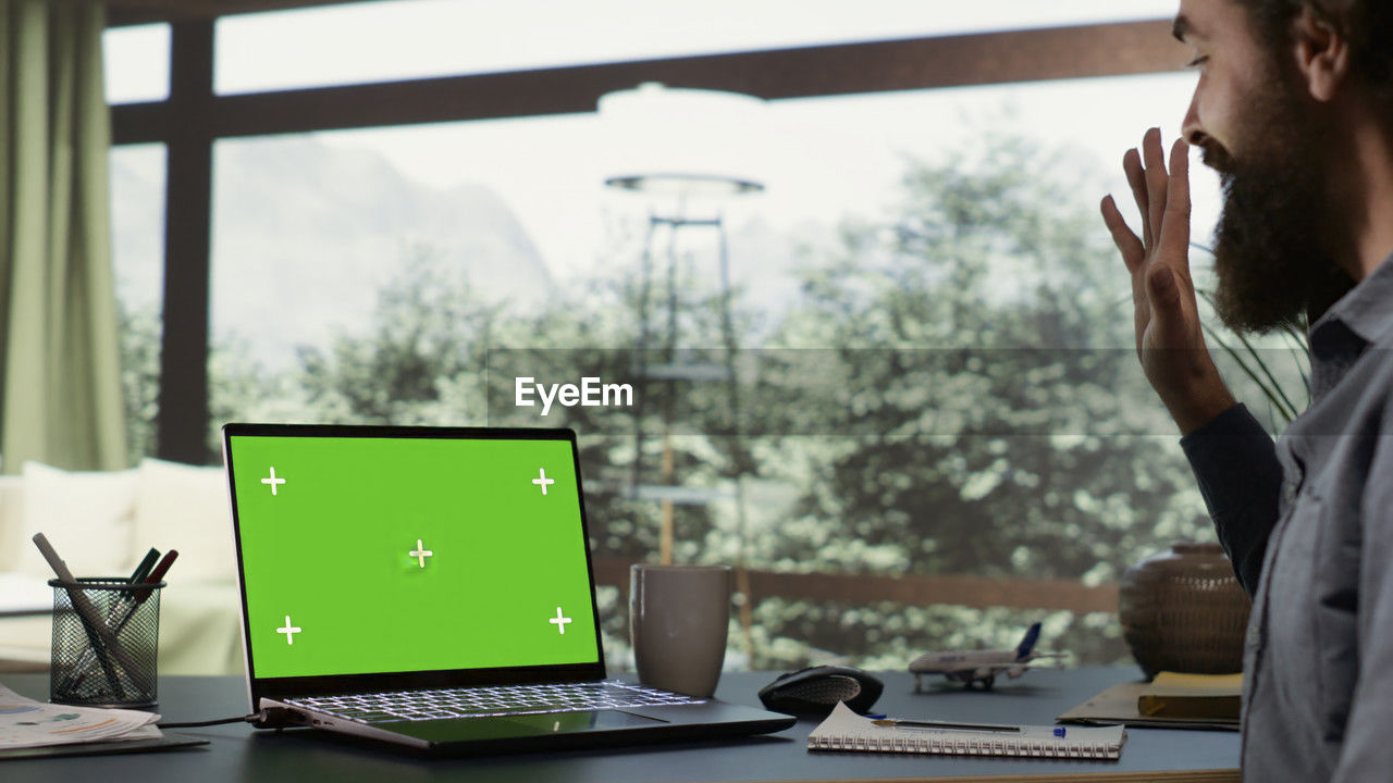 side view of man using laptop on table