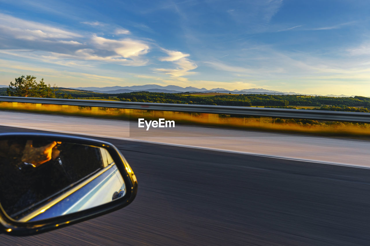 Reflection of road against sky during sunset