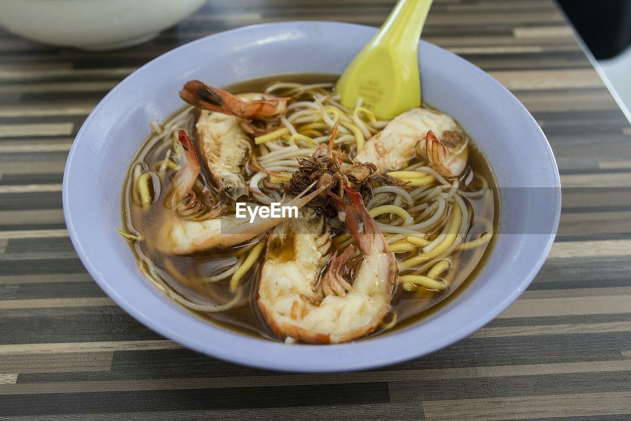 Close-up of served prawns noodle soup