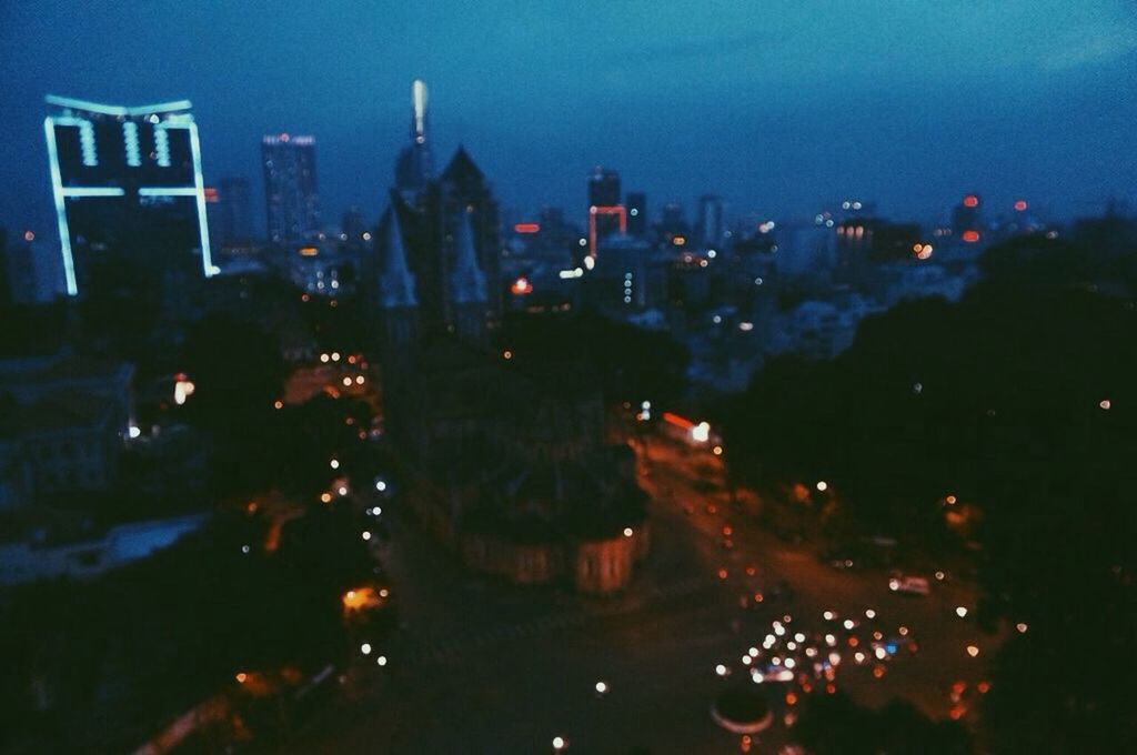 VIEW OF ILLUMINATED CITY AT NIGHT