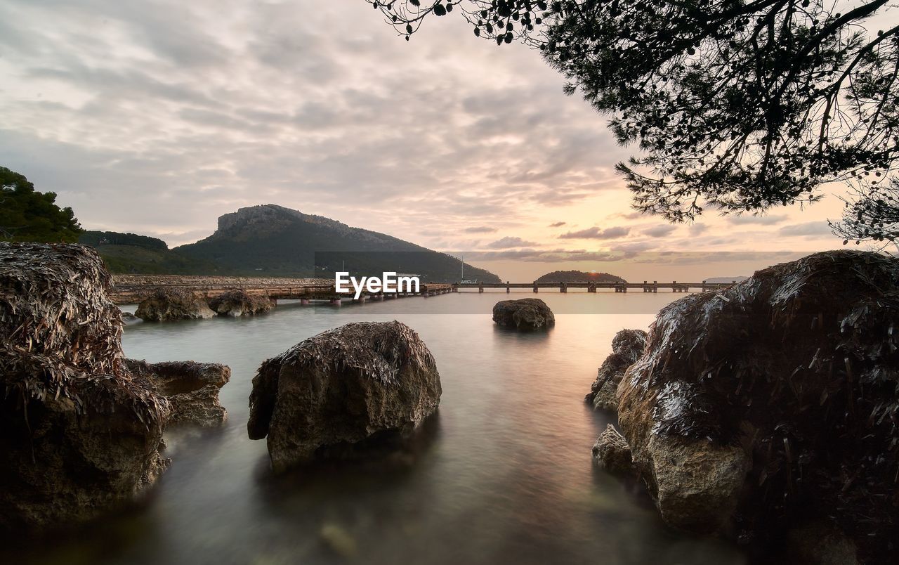 water, nature, sky, rock, sea, scenics - nature, cloud, body of water, beauty in nature, morning, reflection, land, landscape, environment, coast, shore, tree, tranquility, no people, beach, travel destinations, outdoors, travel, plant, tranquil scene, dusk, mountain, long exposure, seascape, coastline, tourism, ocean, sunlight, idyllic, motion