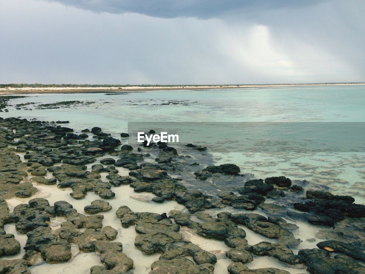 Scenic view of sea against cloudy sky