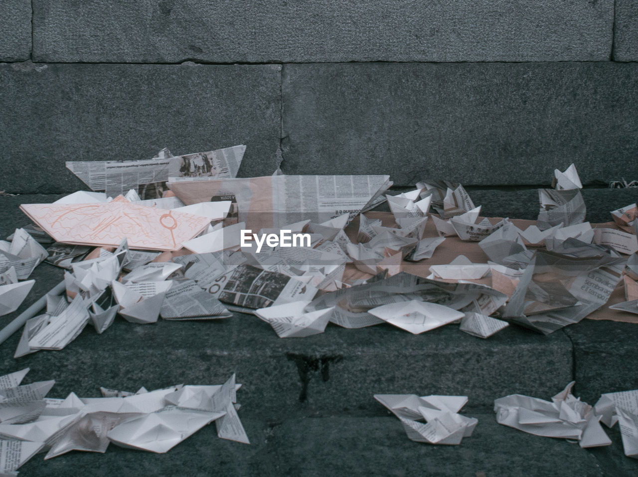 Paper boats on stone steps