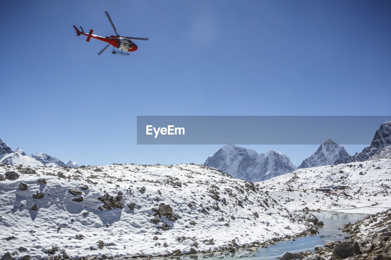 A helicopter approaches a landing pad near mt everest base camp, nepal