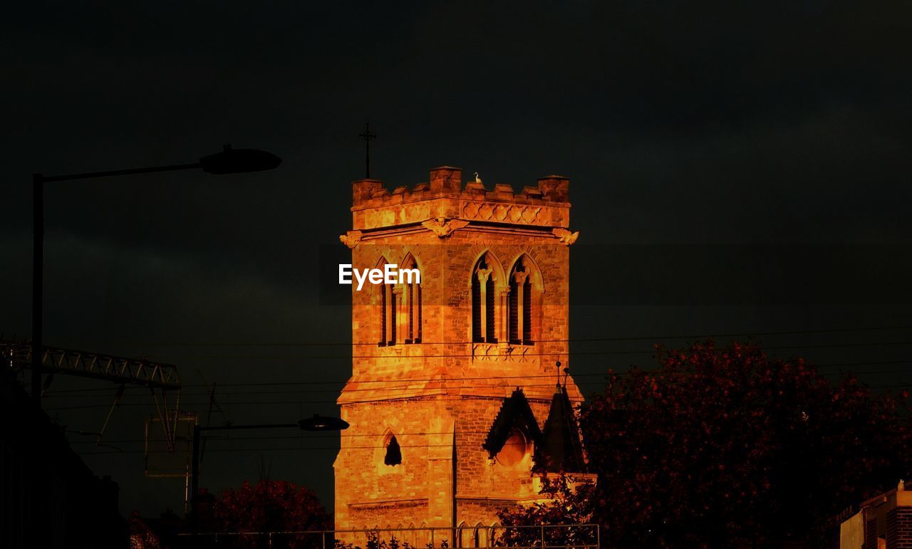 LOW ANGLE VIEW OF ILLUMINATED BUILDING