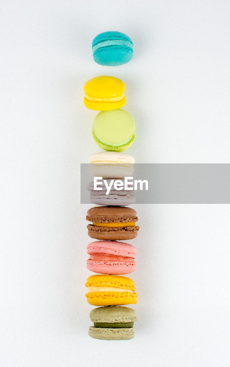 Delicious macarons tower on white background