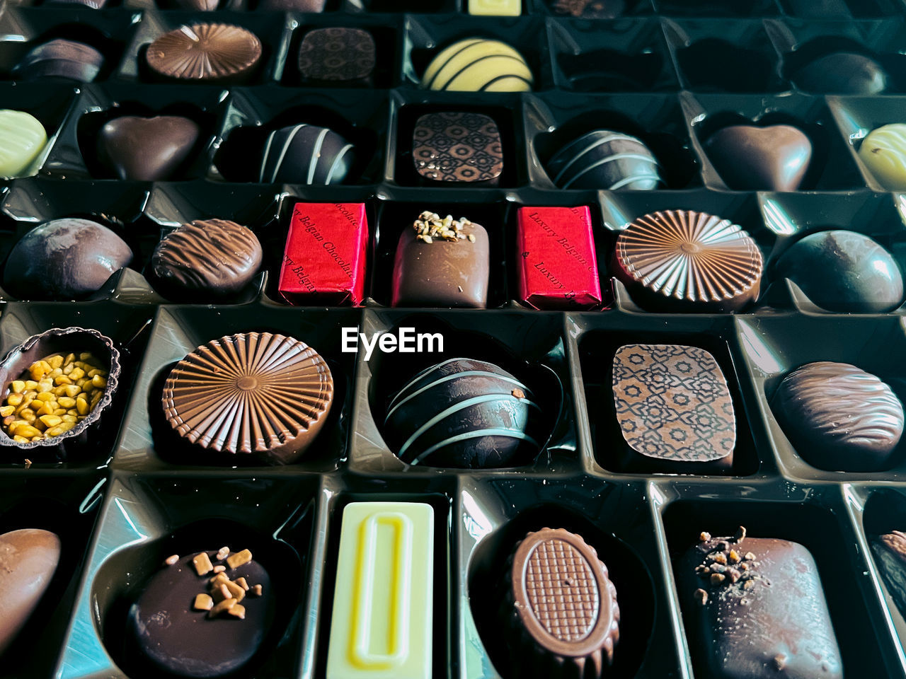 chocolate, bonbon, confiture, large group of objects, variation, food, no people, arrangement, high angle view, in a row, dessert, abundance, food and drink, still life, full frame, indoors, directly above, multi colored, backgrounds, container