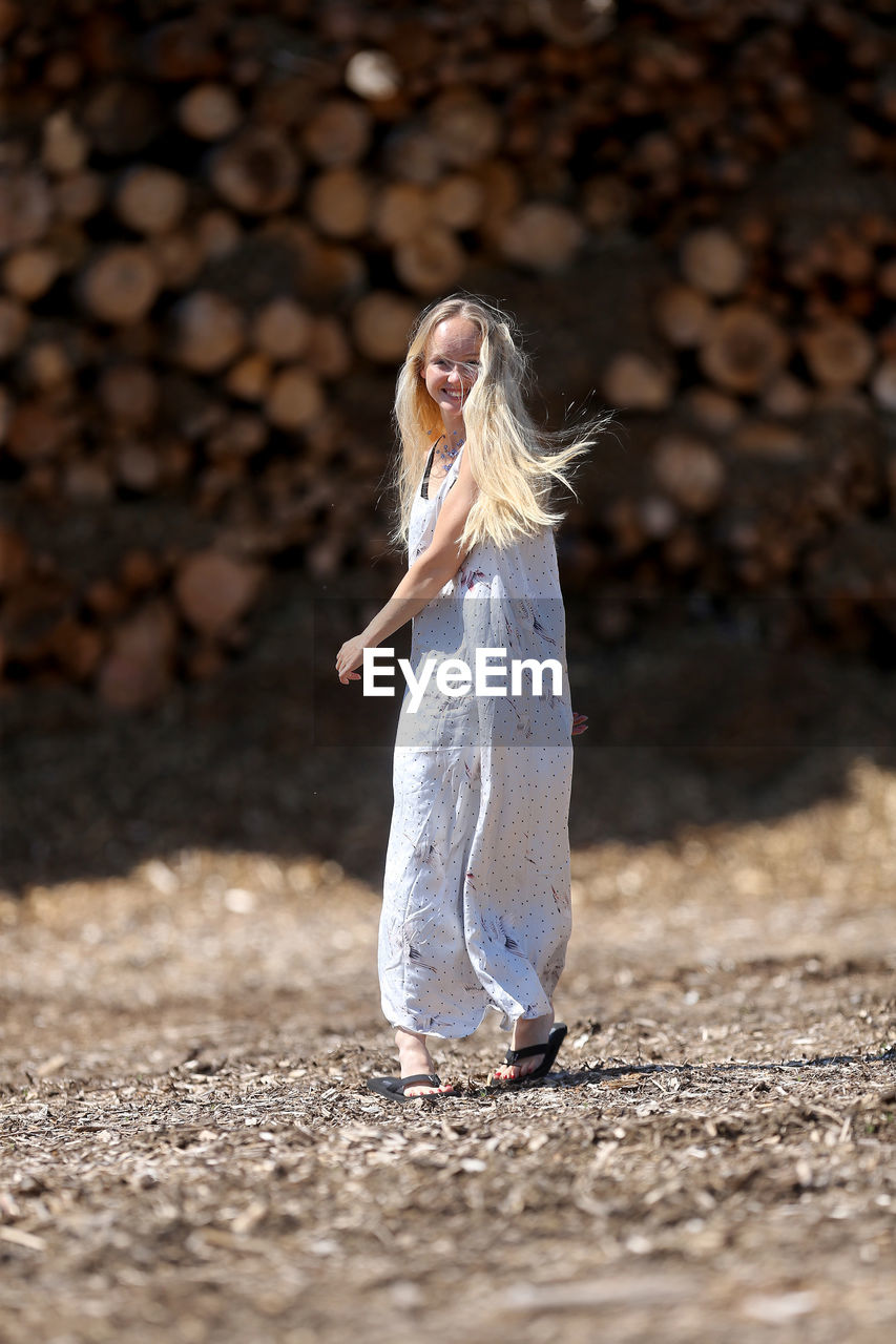 Low section of woman with umbrella on land