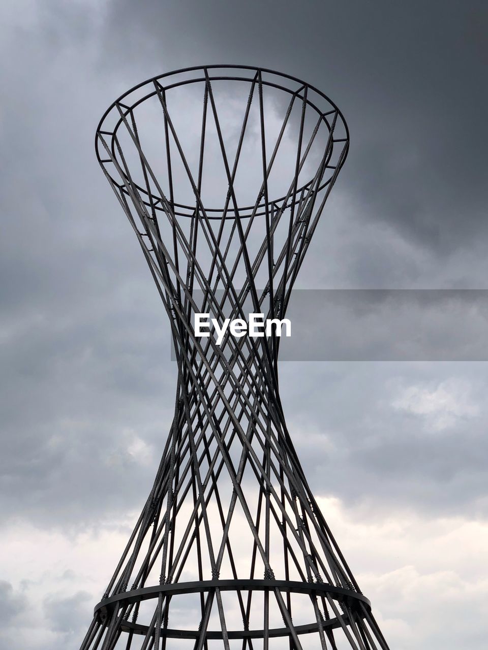 Low angle view of iron monument hoop against sky