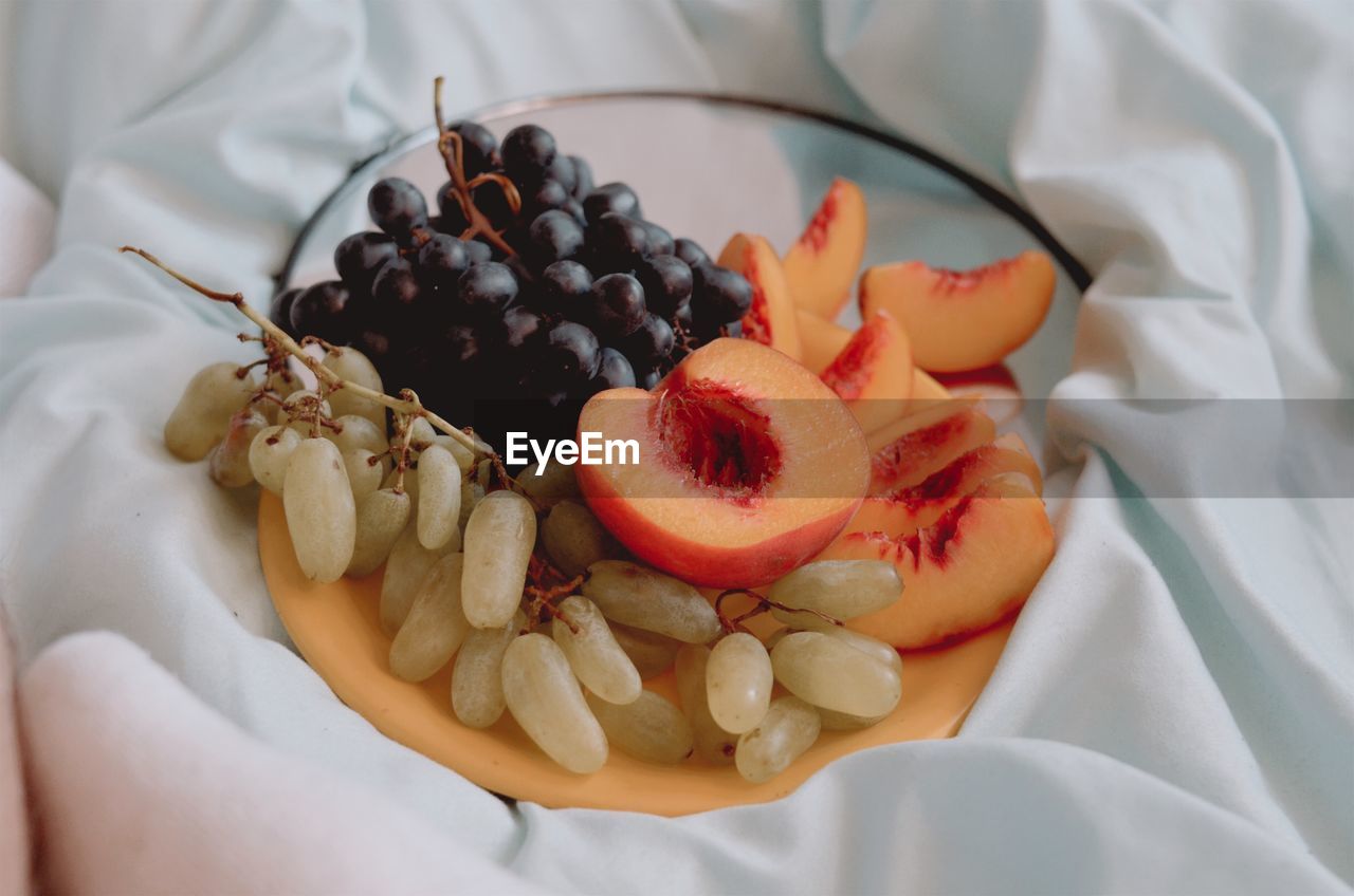 High angle view of breakfast with fruit on bed