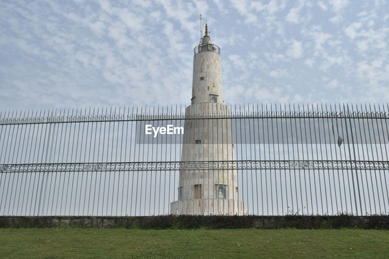 architecture, built structure, sky, building exterior, tower, day, nature, no people, cloud, grass, travel destinations, building, travel, outdoors, plant, fence, tourism, security, history, the past, protection, field