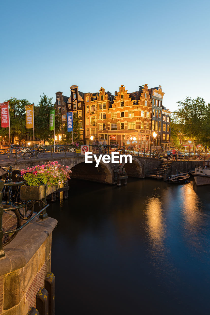 Amsterdam canals with bridge and traditional dutch houses, netherlands